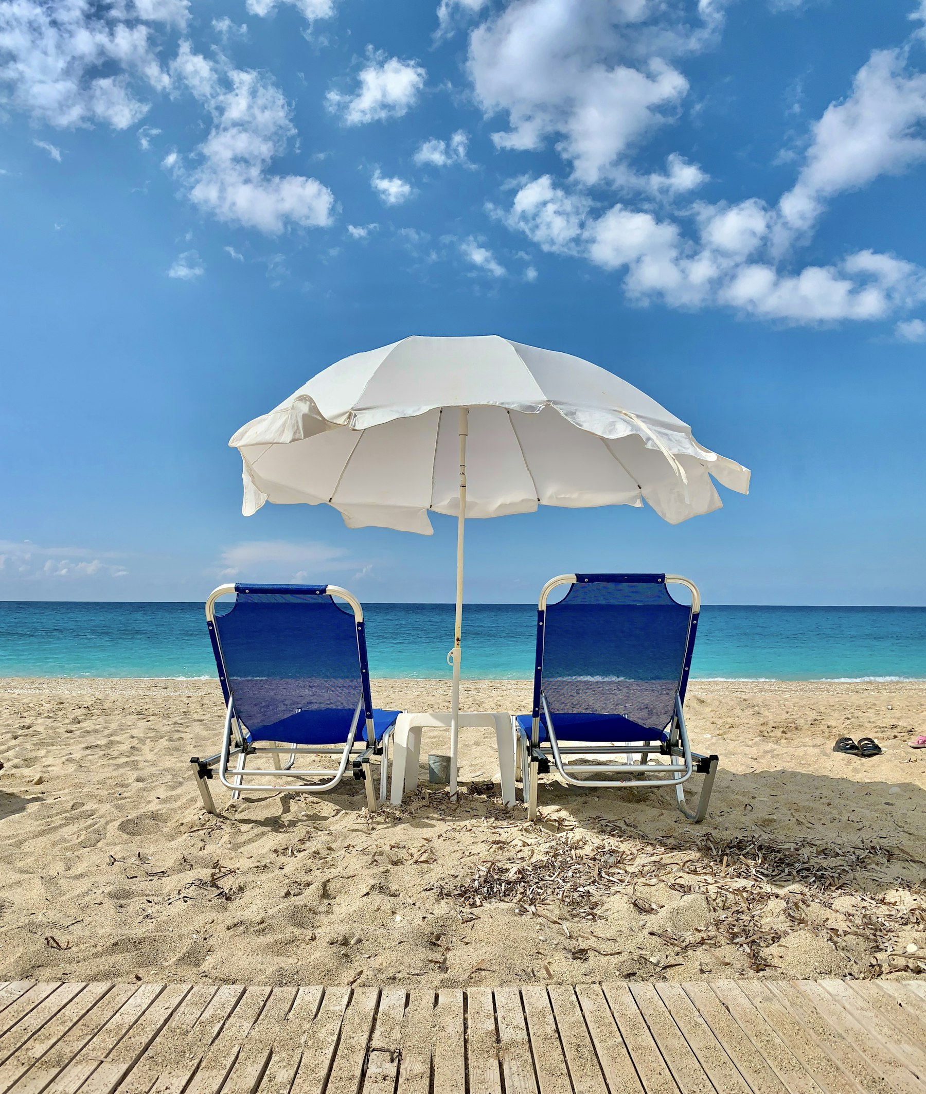 Shaded canopy and beach chairs set up on the sand